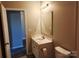 Bathroom featuring a single sink vanity and toilet, neutral colored walls and tile floors at 195 Willow Valley Dr, Mooresville, NC 28115