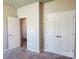 Bedroom with carpet floors and neutral colored walls with closet that features bi-fold doors at 195 Willow Valley Dr, Mooresville, NC 28115