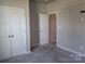 Bedroom with carpet floors, closet with bi-fold doors, and neutral colored walls at 195 Willow Valley Dr, Mooresville, NC 28115