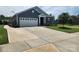 Well-maintained home featuring an attached garage and long driveway, set on a tidy, grassy lot at 195 Willow Valley Dr, Mooresville, NC 28115