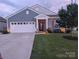 Well-kept home with a pristine lawn, framed by mature landscaping and a tree-lined street at 195 Willow Valley Dr, Mooresville, NC 28115