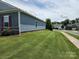 Side view of a well maintained home on a lawn with tidy landscaping at 195 Willow Valley Dr, Mooresville, NC 28115