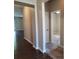 Hallway with dark wood floors and neutral colored walls with views to other rooms at 195 Willow Valley Dr, Mooresville, NC 28115