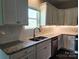 Well-lit kitchen boasts white cabinets, granite countertops, and stainless steel appliances at 195 Willow Valley Dr, Mooresville, NC 28115