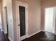 Close up of pantry with glass door and dark wood flooring at 195 Willow Valley Dr, Mooresville, NC 28115
