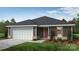 Charming single-story home with a two-car garage, neat landscaping, and a welcoming entrance at 2025 Cunningham Farm Dr, Indian Trail, NC 28079