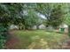 An expansive backyard offering a lush lawn, storage shed, and ample space for gardening and outdoor activities at 2130 Chesterfield Ave, Charlotte, NC 28205