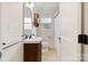 Updated bathroom features a new vanity, mirror and tiled floors at 2130 Chesterfield Ave, Charlotte, NC 28205