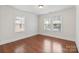 Bright bedroom with hardwood floors, white walls, and large windows at 2130 Chesterfield Ave, Charlotte, NC 28205