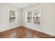 Bright bedroom with hardwood floors, two windows, and white walls at 2130 Chesterfield Ave, Charlotte, NC 28205