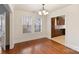 Dining room features hardwood floors, a large window, white walls, and a view to the kitchen at 2130 Chesterfield Ave, Charlotte, NC 28205
