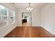 Dining room features hardwood floors, a large window, white walls, and a view to the kitchen at 2130 Chesterfield Ave, Charlotte, NC 28205