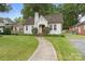A well-maintained home with a brick chimney, manicured lawn, and charming curb appeal at 2130 Chesterfield Ave, Charlotte, NC 28205