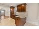 Updated kitchen with granite countertops and tile backsplash that connects to the dining area at 2130 Chesterfield Ave, Charlotte, NC 28205