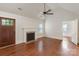 Bright living room features vaulted ceiling, ceiling fan, hardwood floors, fireplace, and a view into the next room at 2130 Chesterfield Ave, Charlotte, NC 28205