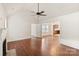 Bright living room features vaulted ceiling, ceiling fan, hardwood floors, fireplace, and a view into the next room at 2130 Chesterfield Ave, Charlotte, NC 28205