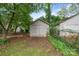 A shed in the backyard featuring functional storage, complemented by a grassy lawn and some mature trees at 2130 Chesterfield Ave, Charlotte, NC 28205