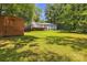 Grassy backyard featuring a shed and a deck at 2222 19Th Ne Ave, Hickory, NC 28601