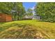 Large, grassy backyard with mature trees, a shed, and a wooden deck at 2222 19Th Ne Ave, Hickory, NC 28601