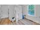 Bright bathroom with a tub and shower combination, wood look floors and a white bathrobe hanging at 2222 19Th Ne Ave, Hickory, NC 28601