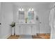 Bathroom featuring a double sink vanity, hardwood floors, and modern lighting at 2222 19Th Ne Ave, Hickory, NC 28601