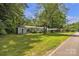 Single-story home has a well-maintained lawn, covered carport, and mature trees at 2222 19Th Ne Ave, Hickory, NC 28601