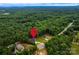 Aerial view showcasing the home's location nestled in a lush, green forest setting with mountain views at 240 Mark Ryan Ln, Dallas, NC 28034