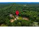 Aerial view showcasing the home's location nestled in a lush, green forest setting with mountain views at 240 Mark Ryan Ln, Dallas, NC 28034