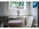Freestanding tub features modern fixtures, towels and bright natural light at 240 Mark Ryan Ln, Dallas, NC 28034