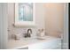 Modern bathroom featuring a sleek sink, elegant fixtures, and a well-lit vanity area at 240 Mark Ryan Ln, Dallas, NC 28034