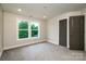 A carpeted bedroom features recessed lighting, fresh paint, two windows and a closet door at 240 Mark Ryan Ln, Dallas, NC 28034