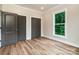 Bedroom featuring wood floors, neutral walls, and multiple closet doors, offering ample storage space at 240 Mark Ryan Ln, Dallas, NC 28034