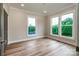 Bright bedroom with three windows, hardwood floors, and neutral paint, creating a serene retreat at 240 Mark Ryan Ln, Dallas, NC 28034
