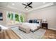Bedroom with wood floors, large windows, upholstered bed frame and neutral decor at 240 Mark Ryan Ln, Dallas, NC 28034