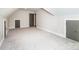 Large, carpeted bonus room with 3 access doors and an attic access at 240 Mark Ryan Ln, Dallas, NC 28034