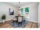 Charming dining area with a round black table, natural light, and modern artwork at 240 Mark Ryan Ln, Dallas, NC 28034