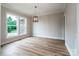 Dining area featuring wood floors, a modern chandelier, and natural light from a large window at 240 Mark Ryan Ln, Dallas, NC 28034