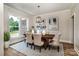 Elegant dining room with natural light, stylish table setting, and modern decor, perfect for gatherings at 240 Mark Ryan Ln, Dallas, NC 28034
