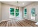 Dining area filled with natural light, featuring modern light fixture and wood-look floors at 240 Mark Ryan Ln, Dallas, NC 28034