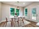 Bright dining room featuring a white table and chairs complemented by hardwood floors and natural light at 240 Mark Ryan Ln, Dallas, NC 28034