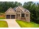 Charming brick two-story home featuring a two-car garage and lush green landscaping at 240 Mark Ryan Ln, Dallas, NC 28034