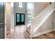 Grand foyer with wood floors, a staircase, and an ornate front door with side lights at 240 Mark Ryan Ln, Dallas, NC 28034