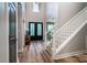 Grand two-story foyer with elegant staircase, decorative front doors, and wood flooring at 240 Mark Ryan Ln, Dallas, NC 28034
