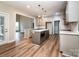 Open-concept kitchen featuring an island with white countertop, stainless appliances, and hardwood floors at 240 Mark Ryan Ln, Dallas, NC 28034