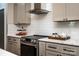 Modern kitchen featuring stainless steel appliances, light gray cabinets, and white subway tile backsplash at 240 Mark Ryan Ln, Dallas, NC 28034
