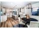 Open-concept kitchen featuring an island, stainless steel appliances, and a dining area with modern lighting at 240 Mark Ryan Ln, Dallas, NC 28034