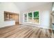 Bright living room with wood floors, fireplace, and open access to modern kitchen with island at 240 Mark Ryan Ln, Dallas, NC 28034