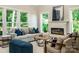 Cozy living room with large windows offering serene views and a fireplace at 240 Mark Ryan Ln, Dallas, NC 28034