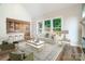 Bright living room with large windows, a modern fireplace, and an open view into the kitchen at 240 Mark Ryan Ln, Dallas, NC 28034