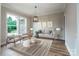 Cozy living room with a light gray sofa and decor, complemented by hardwood floors and natural light at 240 Mark Ryan Ln, Dallas, NC 28034